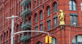 Manhattan, New York, USA - 31st May 2017 : View of the famous Puck building with a gilded statue of Shakespeare's character Puck at Wagner Graduate School of Public Service in Lower Manhattan