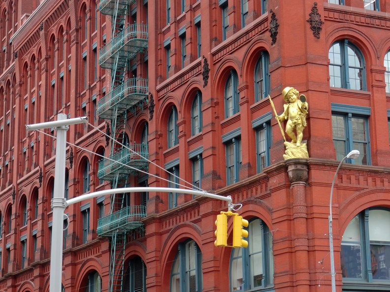Manhattan, New York, USA - 31st May 2017 : View of the famous Puck building with a gilded statue of Shakespeare's character Puck at Wagner Graduate School of Public Service in Lower Manhattan
