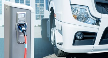 Electric vehicles charging station on a background of a truck. Concept