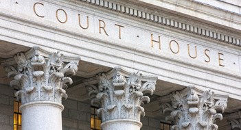 Facade of courthouse with columns.