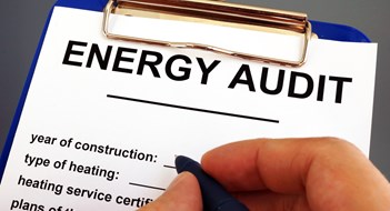 DOB Deadline: Man filling in energy audit form in a clipboard.