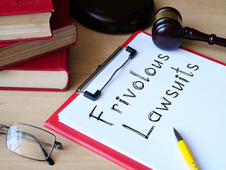 Frivolous lawsuits is shown on a conceptual photo using the text