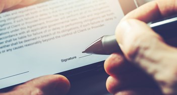 Management Contracts 101 electronic signature concept - man sign distance contract with digital pen in mobile phone