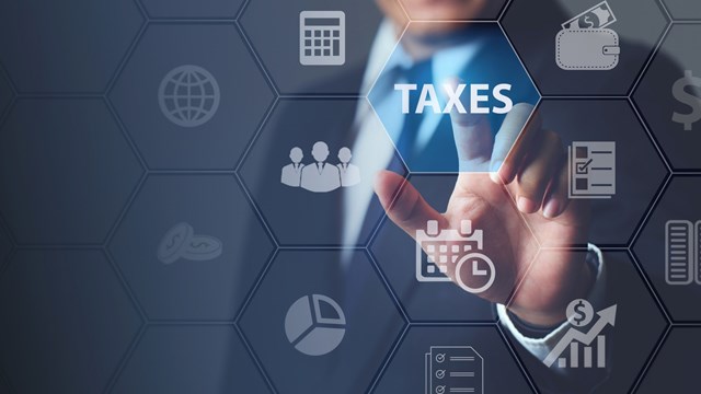 Businessman using innovative virtual touchscreen presses taxes button.with icons state taxes.Data analysis,paperwork,financial research,report.Calculation tax return surrounding.taxes Concept