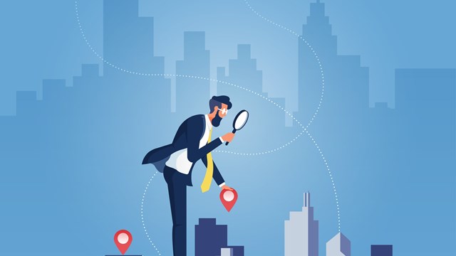 Businessman holding magnifying glass and Building, building selection