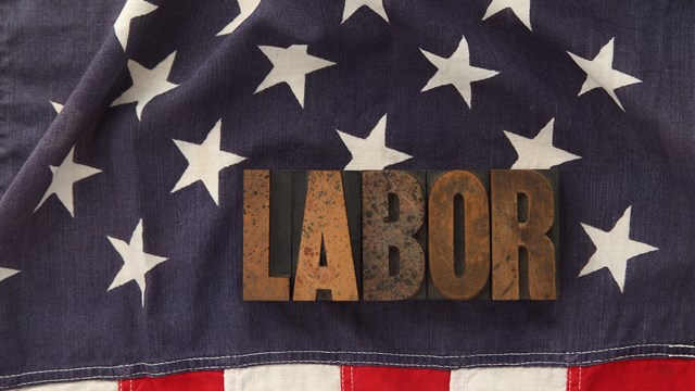 the word labor in old letterpress wood type on an old flag
