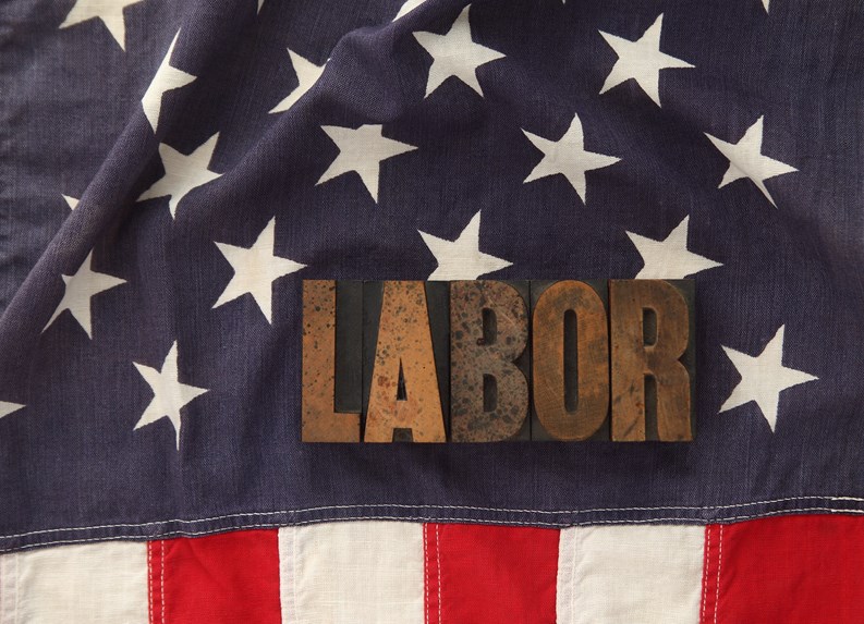 the word labor in old letterpress wood type on an old flag