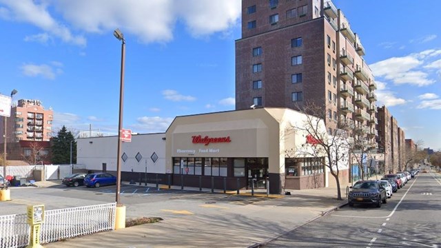 A parking lot, Walgreens pharmacy store, and mid-rise apartment building in Woodside, Queens, New York