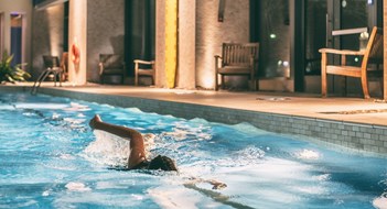 Swimmer exercising in a condo's indoor pool 