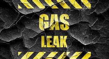 Understanding Local Law 157—NYC’s Gas Detector Law Gas Leak warning sign in yellow block letters on cracked black background