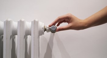 white radiator on a light wall in the room