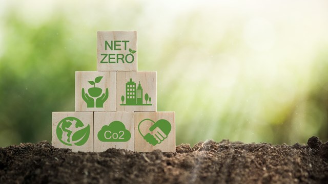 Climate-neutral long-term strategy greenhouse gas emissions targets Wooden block with green net center icon. Carbon neutral and net zero concept natural environment.