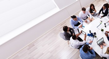 Group Of Multi Ethnic Business Team Sitting Together At Workplace In Modern Office