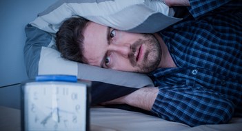 Q&A: Noisy Neighbors Man feeling tired in the morning after a bed sleep