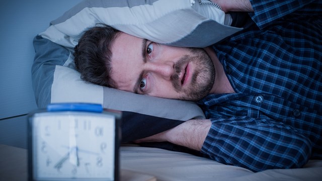 Man feeling tired in the morning after a bed sleep