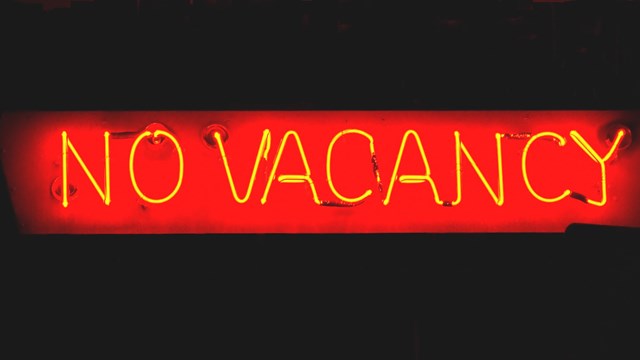 Red neon sign of "No Vacancy" at night