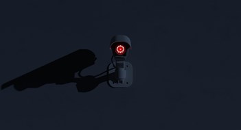 Q&A: Camera? Action! Surveillance camera glowing in the dark. Ominous mood scene with negative space. Digital 3D rendering.