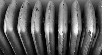 An old dark brown radiator in a kitchen