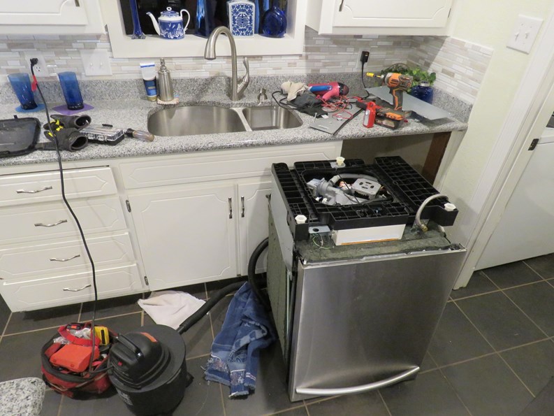 kitchen dishwasher being repaired