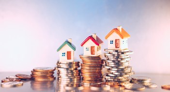 Navigating Today's Mortgage Market Miniature colorful house on stack coins using as property and financial concept