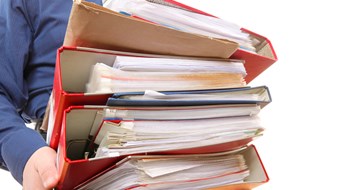 Man holding stack of folders. Pile with old documents and bills. Isolated on white background