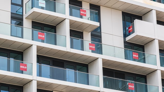 Brand new empty apartments with sold and available signs around Finsbury Park in London
