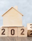 flip 2022 to 2023 block with house model. real estate, Home loan, tax, investment, financial, savings and New Year Resolution concepts