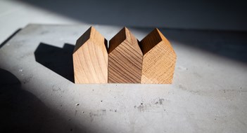 Just Like a Good Neighbor... Group of similar wooden tiny toy houses. Wooden models of buildings as conceptual images for real estate topics.