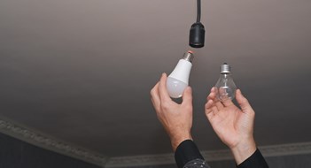 The concept of energy saving. incandescent lamp and energy-efficient LED lamp in your hands.