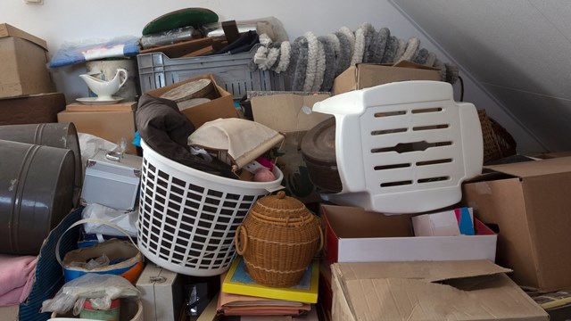 Pile of junk in a house, hoarder room pile of household equipment needs clearing out storage