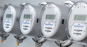 Multifamily Co-Generation Digital electric meters in a row measuring power use. Electricity consumption concept. 3d illustration