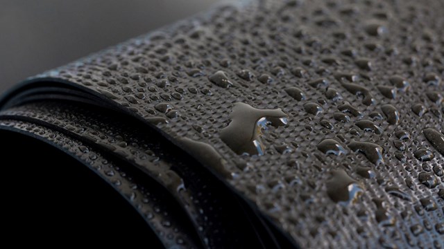 Water droplets on the rubber membrane. Waterproofing...  Close-up selective focus area.