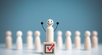 How To Win a Board Election Raise hand wooden figure stands above a wooden cube with vote symbol among another. open-mindedness or public hearing, Elections concept. Volunteers, parties, candidates, constituency electorates.