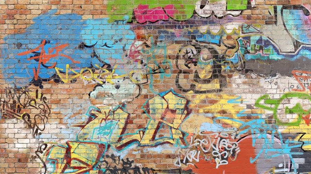 Graffiti on brick wall, composite of various images, layered and altered digitally so as to be non-identifiable.