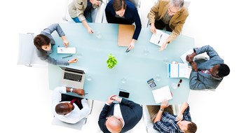 Making the Most of Your Annual Meeting Overhead view of a group of business people at meeting.