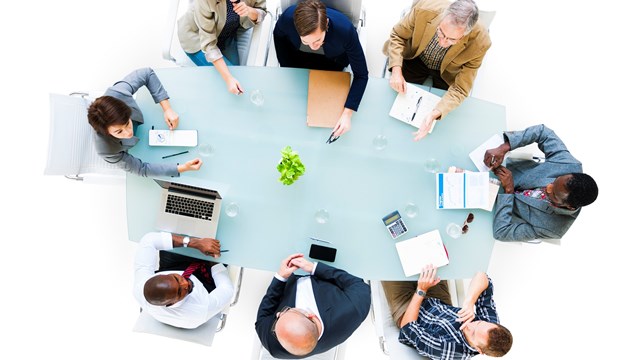 Overhead view of a group of business people at meeting.