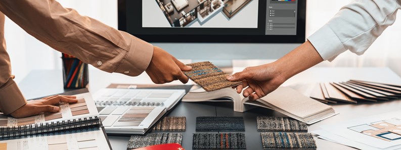 Group of interior architect designer team at table choosing various mood board samples with architecture software on laptop screen. Modern renovation and interior material selection concept. Insight