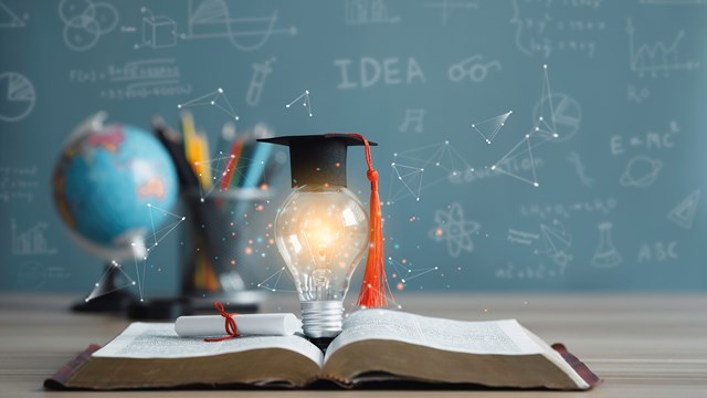 Graduation cap with a lightbulb on the book and globe in the classroom. Education learning concepts in school or university. Idea knowledge of innovative technology, science, and mathematics.