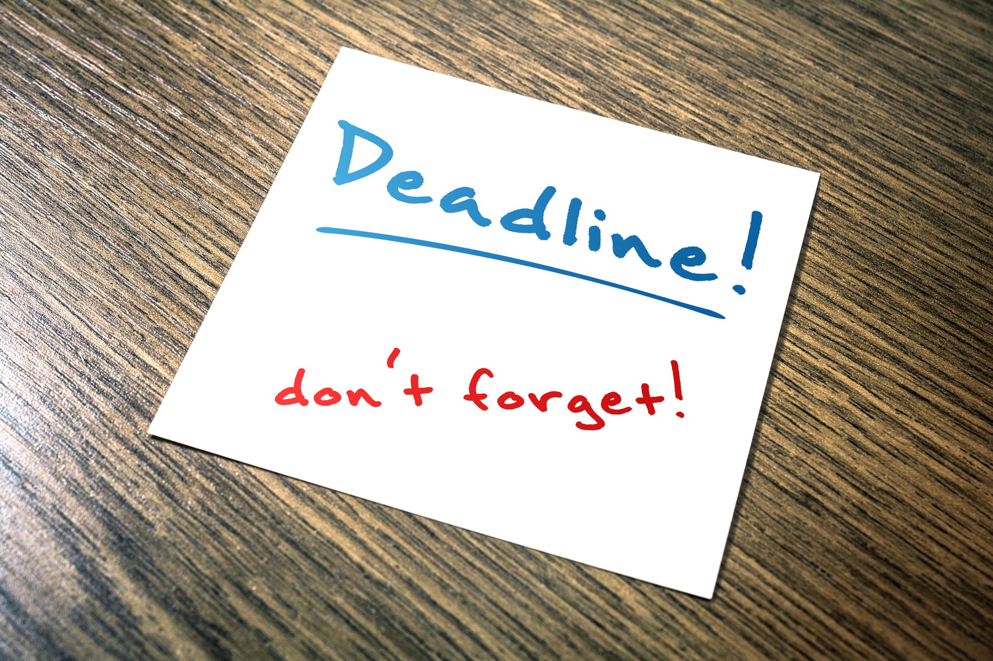 Deadline Reminder On Paper Lying On Wooden Cupboard