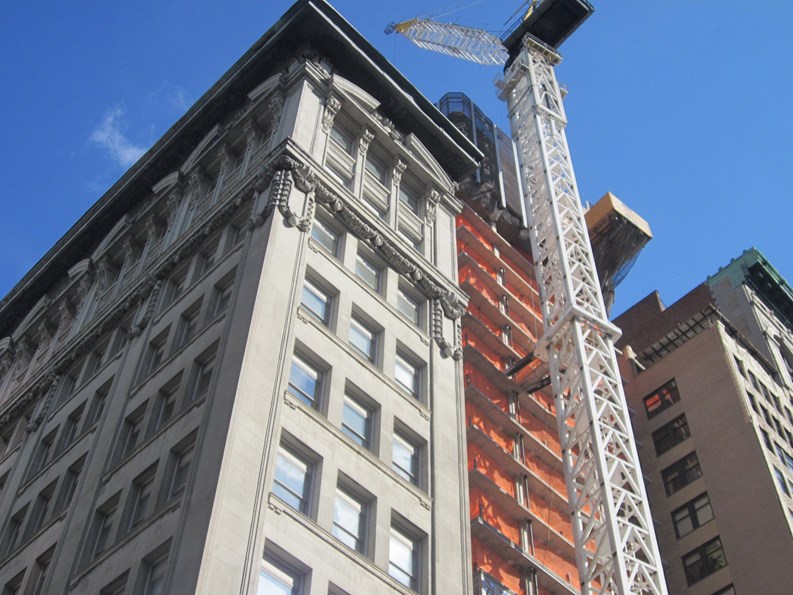 Shot taken of Manhattan building under construction during summer months.