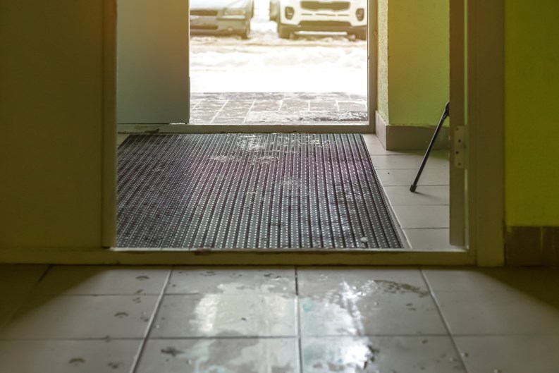 wet and muddy in the stairwell, slush in winter or spring, exit to the street